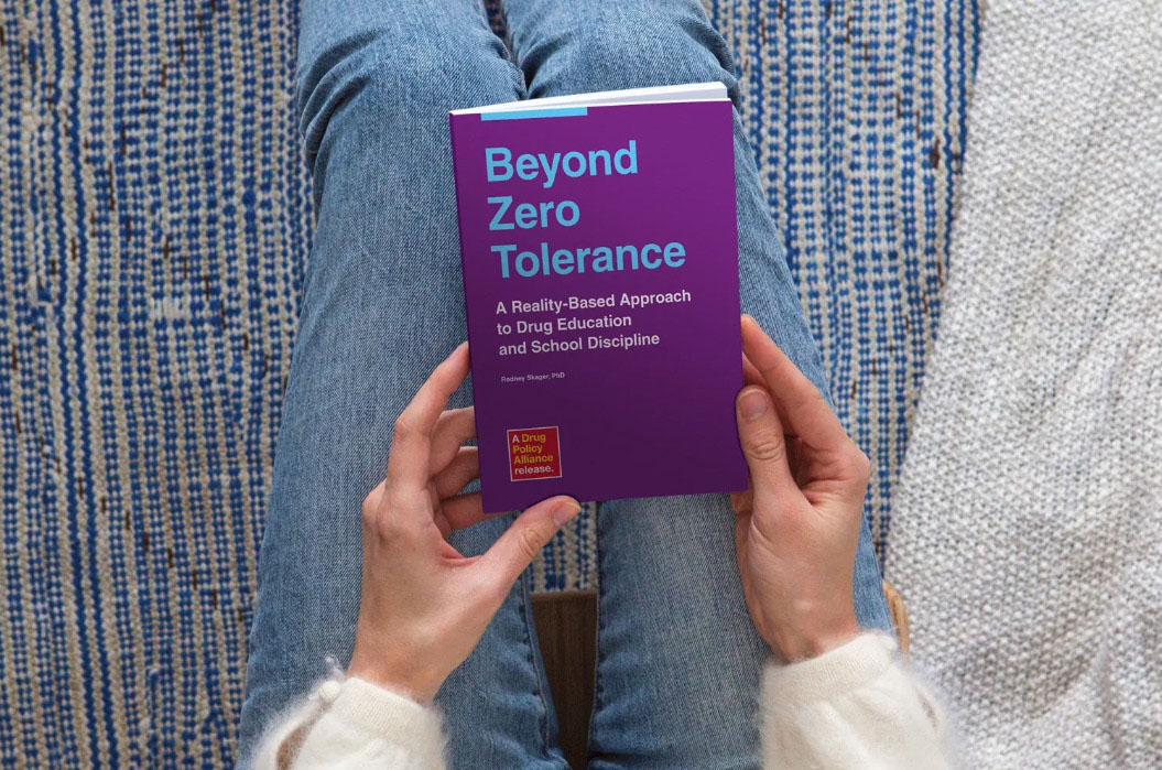 Person reading Beyond Zero Tolerance booklet